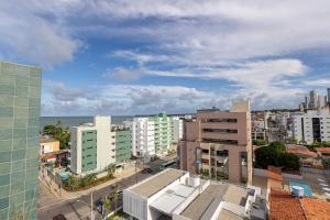 an aerial view of a city with buildings and the ocean at Oceânica Cabo Branco By Carpediem in Tambaú
