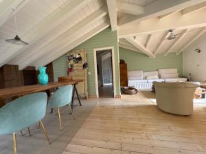 a living room with green walls and a table and chairs at Le Vetrate sul Lago Lake Como Amazing View in Nesso