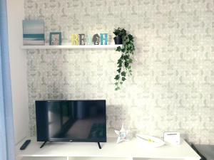 a television sitting on a table in a living room at Beach house near the sea with pool in Puerto del Carmen