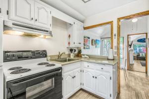 a white kitchen with a stove and a sink at 322S 322 Sumner Ave in Avalon +13 photos