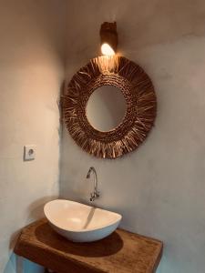 a bathroom with a sink and a mirror on the wall at Cozy bliss homestay sidemen in Sidemen +54 photos