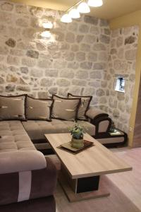 a living room with a couch and a table at Piano apartments in Kotor