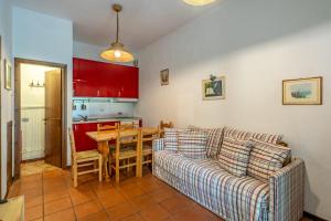 a living room with a couch and a table at Residence Sole - Adamello in Ponte di Legno +6 photos