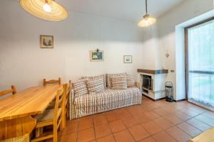 a living room with a couch and a table at Residence Sole - Adamello in Ponte di Legno