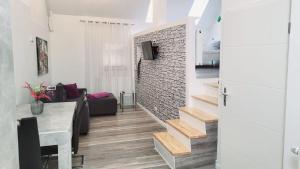 a living room with a couch and a stairway at Ferienwohnung Jasmin in Rust