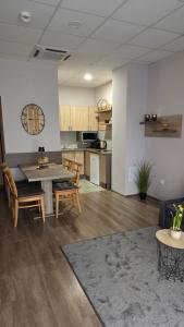 a living room and kitchen with a table and chairs at Dorka Apartman Zalakaros in Zalakaros
