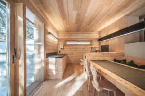 a kitchen with a long table in a tiny house at Mountain Lodge Tamersc in San Vigilio Di Marebbe