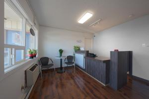 an office with two chairs and a desk and a table at OYO Hotel St Helens OR in Saint Helens