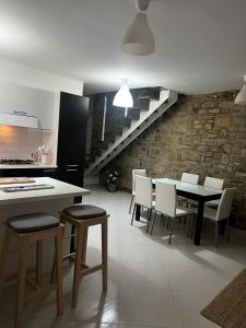 eine Küche und ein Esszimmer mit Tisch und Stühlen in der Unterkunft Castellabate Apartments Casa dell'Arco in Castellabate