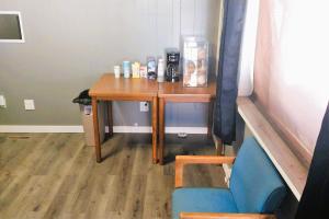 a room with a table and a chair and a desk at Love Hotels Desert Inn & RV by OYO at Boysen Wind River WY in Shoshoni
