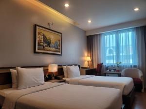 Postel nebo postele na pokoji v ubytování Luxeden Hotel Hanoi