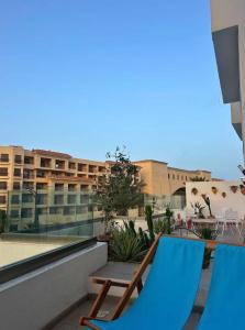 a couple of blue chairs on a balcony at Luxueux appartement en bord de mer in Sousse
