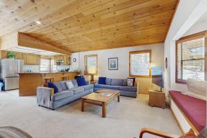 a living room with blue couches and a table at Tuna Bush in Truckee