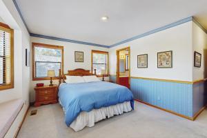 a bedroom with a blue bed and windows at Tuna Bush in Truckee +26 photos