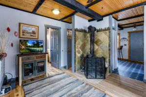a living room with a fireplace and a tv at Sunshine & Snowfall in Silverthorne
