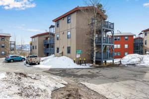 a building in a parking lot with snow around it at Sunshine & Snowfall in Silverthorne
