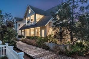 een huis met een houten loopbrug ervoor bij Our Tree House by Oversee 30A in Inlet Beach