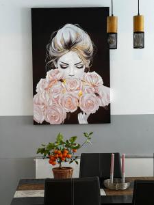 a painting of a woman with pink roses at RumbleintheJungle in Oestrich-Winkel