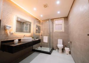 a bathroom with a sink and a toilet at Zones Residence Maadi in Cairo +24 photos