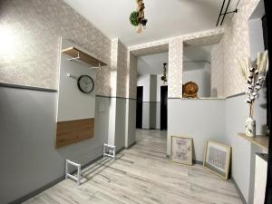 a hallway with white walls and a clock on the wall at RumbleintheJungle in Oestrich-Winkel