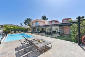 a villa with a swimming pool and a house at Salobre Villa 2 by Villagrancanaria in Salobre