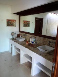 a bathroom with two sinks and a large mirror at Lovely modern beach Villa in Cruz de Huanacaxtle