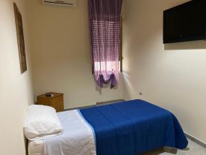 a hospital room with a bed and a television at Casa Alleria in Battipaglia