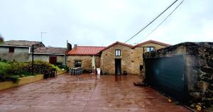 a house with a brick yard with a fence at Casa Bretema Ferrol in La Cabana