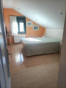 A bed or beds in a room at Hostal Casa Martinez