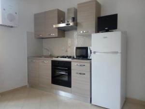 a kitchen with a white refrigerator and a stove at Da Cate in Monterosso al Mare