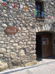 un edificio in pietra con un cartello sul lato di Borda Piñana a Anciles Altre 26 foto