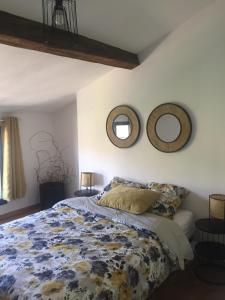 una camera da letto con un letto e due specchi sul muro di LES GITES CHEROIS sweet home maison 8 personnes a Les Chères