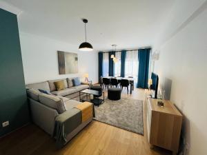 a living room with a couch and a table at Beautiful Apartment - Family and Group of Friends in Póvoa de Santa Iria