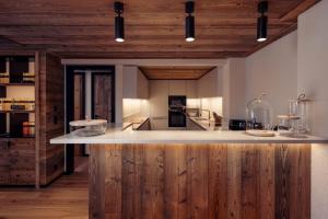 a kitchen with a large island in the middle at Antarès SIRIUS 101 - Prestigious ski inski out apartment in Méribel