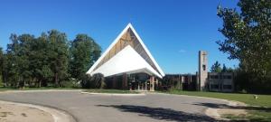 a large building with a large triangular structure at Cabañas Don Pocho in Villa Cura Brochero