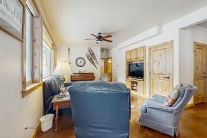 a living room with a blue couch and a table at Deer Trail in McCall