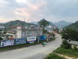 a city street with a building and a car on the road at Bich Phuong Hotel 3 in Ha Giang +11 photos