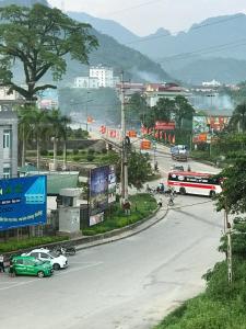a city street with cars and buses on a road at Bich Phuong Hotel 3 in Ha Giang