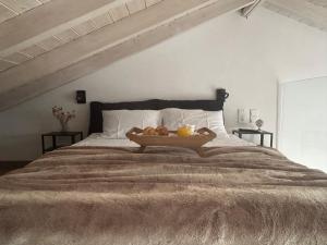 a bed with a tray of fruit on it at CL Luxury Apartment in Kalamata