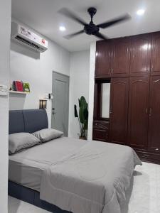 Кровать или кровати в номере H&A Homestay Bandar Tasek Mutiara