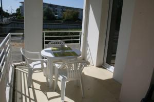 a white table and chairs on a balcony at Appt 2 pièces LA ROCHELLE - LR030-E16 in La Rochelle
