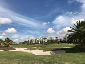 a view of a golf course with palm trees at Arty Apartment - La Torre Golf Resort in Torre-Pacheco