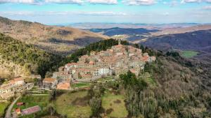 a large building on a hill in the mountains at Le finestre sulle stelle in Gerfalco