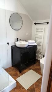a bathroom with a black sink and a mirror at Casa Purcărean in Întorsura Buzăului