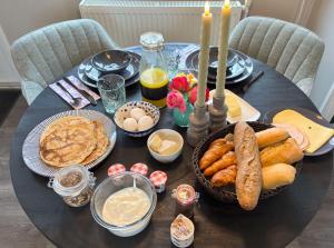 a black table with food and candles on it at B&B bij de Roosjes in Blankenham +51 photos