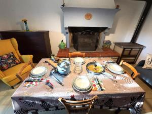 a dining room table with a table cloth and a fireplace at Bosco Stellato in Casteldelci