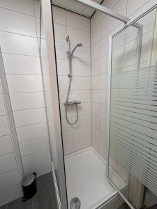 a shower with a glass door in a bathroom at 86 1 City Appartement in Enschede +3 photos
