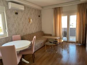 a living room with a couch and a table at Medjugorje Apartments Centre in Međugorje