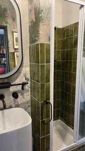 a bathroom with a shower and a sink and a mirror at La galerie in Mulhouse