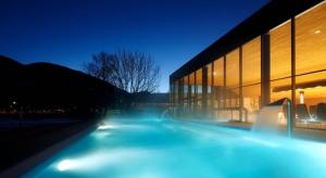 a building at night with blue lights in front of it at Residence Maximilian in Vipiteno